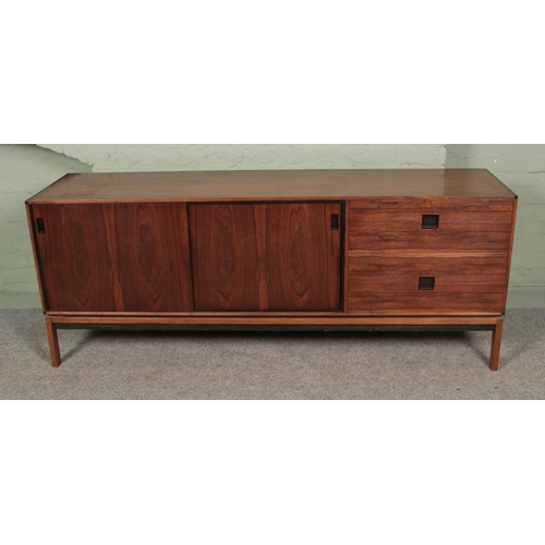 474 - A large retro sideboard featuring four drawers and two sliding doors. Approx. dimensions 192cm x 49.... 