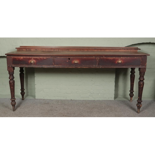 487 - A large Victorian stool height railway station clerks desk with turned legs and cup handle drawers.
... 