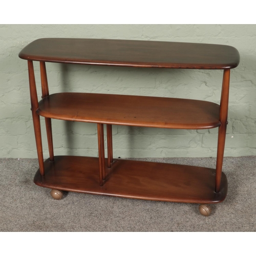 492 - An Ercol three tier trolley bookcase. Approx. dimensions 91cm x 31cm x 71cm