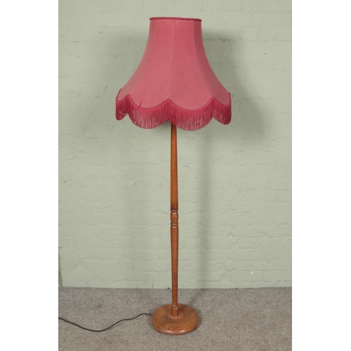 498 - A wooden turned standard lamp