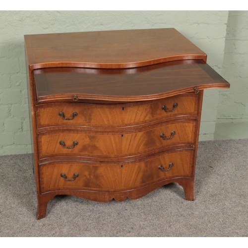 499 - A serpentine chest of four drawers with brushing slide. Approx. dimensions 77cm x 50cm x 78cm.