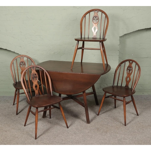 501 - A Ercol elm and beech drop leaf table and four chairs