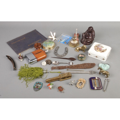 106 - A tray of assorted collectables to include magnifying glass, brass miniatures, hip flask, belt buckl... 