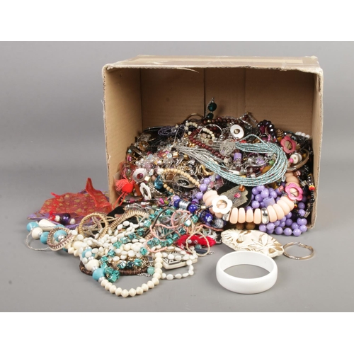 113 - A box of assorted costume jewellery to include beaded necklaces, bangles, bracelets, etc.