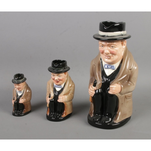 12 - A graduated set of three Royal Doulton character jugs in the form of Winston Churchill.