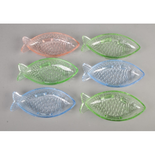 123 - A set of six dishes in the form of fish with varying colours.