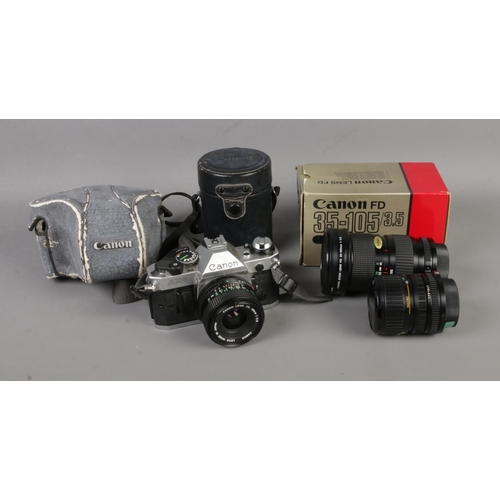 29 - A Canon AE-1 Program 35mm film camera along with collection of Canon lenses. Lenses include 28mm, Zo... 