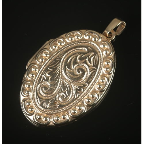 311 - A 9ct gold locket featuring scroll decoration to front. Total weight 4.5g.