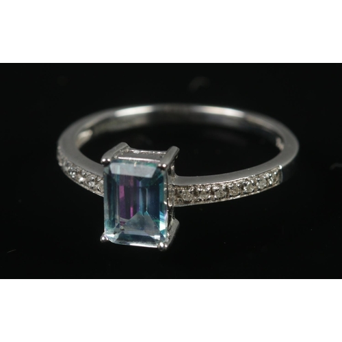 316 - A 9ct white gold ring set with central blue topaz and diamond shoulders. Size N, 2.15g.