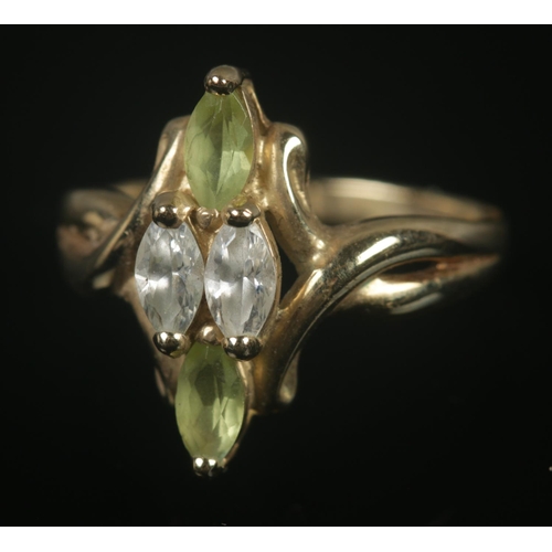 320 - A 9ct gold marquise shaped ring set with green and clear paste stones. Size L, 2.87g.