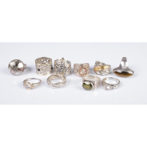 335 - A collection of ten silver rings to include mother of pearl, gemstone set and stacking examples. Tot... 