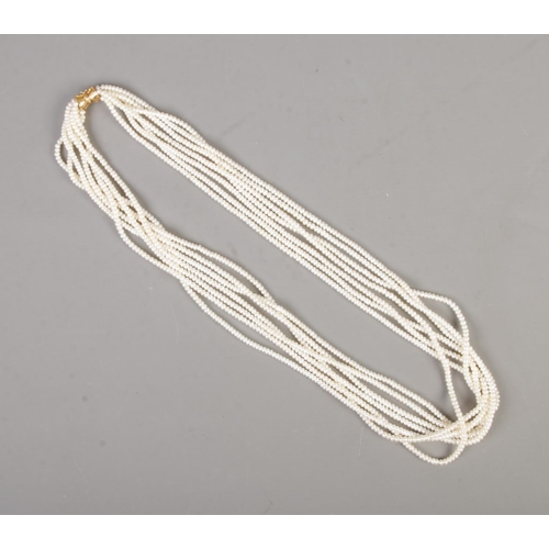 346 - A multi-string cultured pearl necklace featuring 14ct gold clasp.