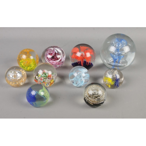 82 - A collection of ten paperweights of varying sizes to include Caithness Weaver 2005 and examples feat... 