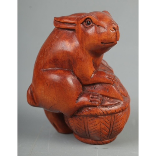 404 - A Japanese carved Netsuke in the form of a rabbit on basket