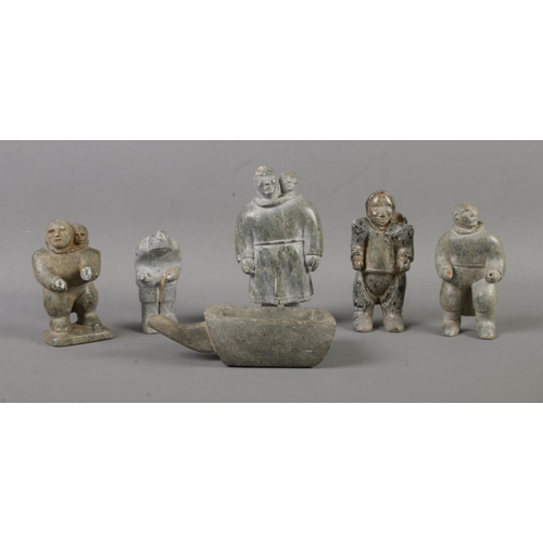 416 - A collection of Inuit carved soapstone figures formed as working villagers. Makers mark carved to ba... 