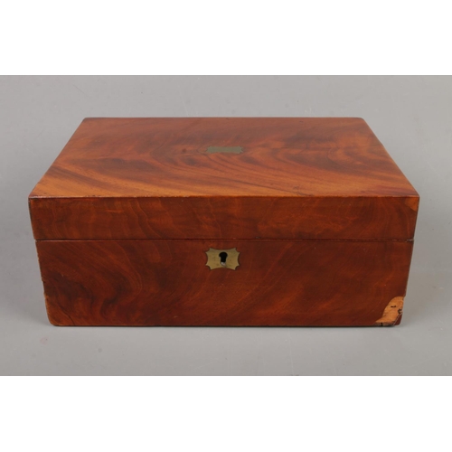 86 - An early 20th century mahogany box with green velvet interior and brass detailing.