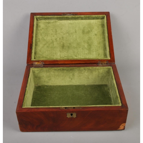 86 - An early 20th century mahogany box with green velvet interior and brass detailing.