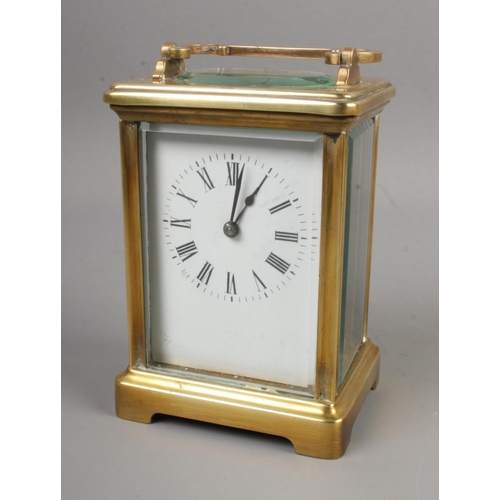 420 - A French carriage clock with open top escapement and Roman numeral markers.