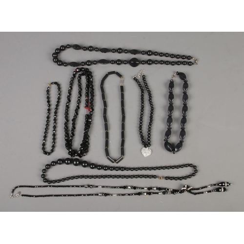 97 - A collection of black beaded necklaces to include French jet and Laura Ashley examples.