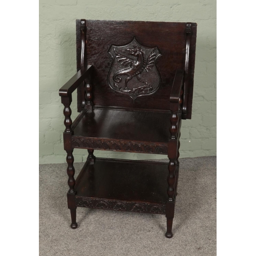 445 - An oak three tier folding top table/hall chair featuring carved dragon cartouche. Approx. dimensions... 