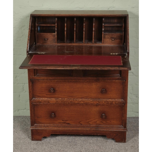 453 - An oak linen fold bureau featuring leather inset top. Approx. dimensions 77cm x 100cm x 44cm.