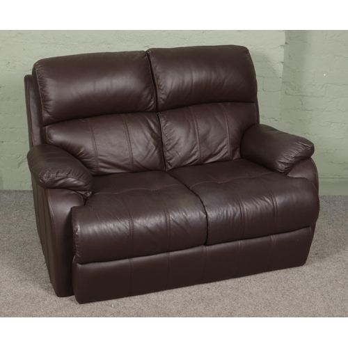 455 - Two brown leather two seater sofas along with a complete leather sofa care kit.