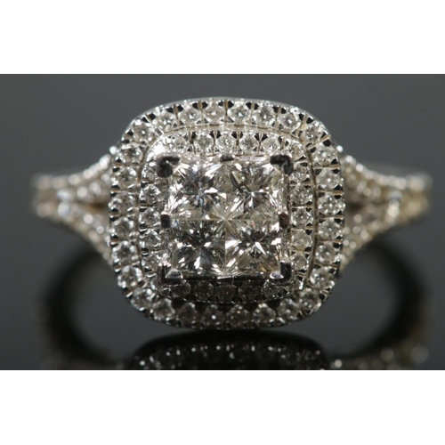 103 - A 14ct white gold diamond cluster ring. The four central square cut diamonds with double halo surrou... 