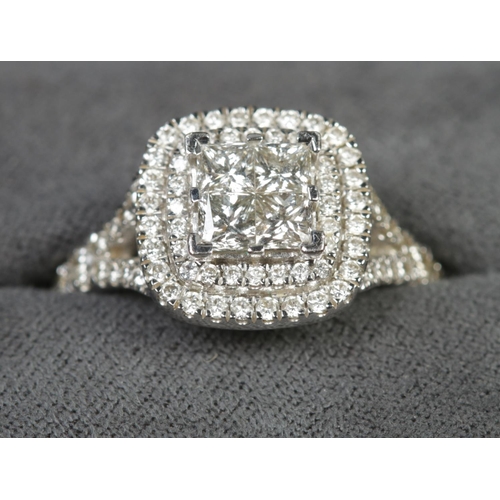 103 - A 14ct white gold diamond cluster ring. The four central square cut diamonds with double halo surrou... 