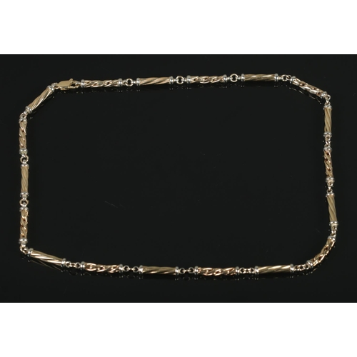 108 - A 9ct yellow and white gold cylindrical link necklace. Length 55cm. 27.5g.