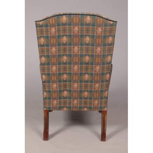 135 - An antique style wing back arm chair raised on carved mahogany ball and claw feet, along with a foot... 