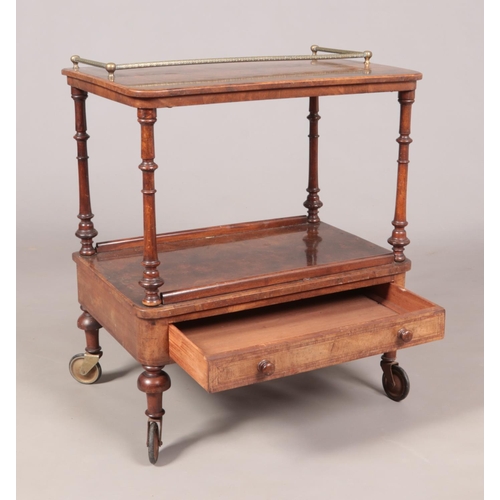 138 - A Victorian walnut two tier side table. Having banded inlaid decoration, gallery top and single draw... 