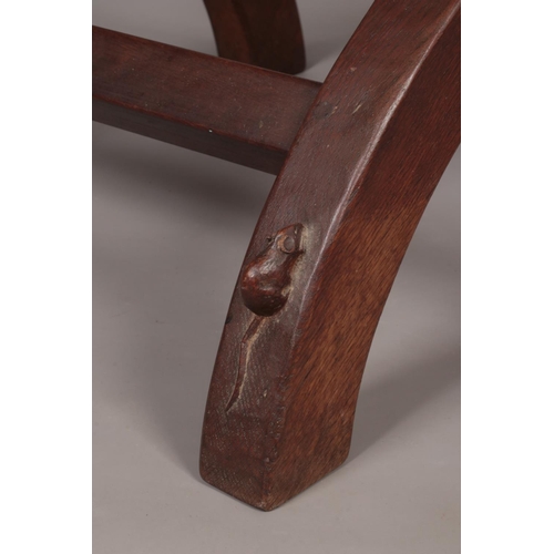 139 - Robert 'Mouseman' Thompson, an oak xframe stool with leather seat. Having carved mouse signature.