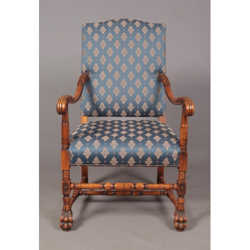 143 - A French style carved walnut throne chair raised on paw feet. Height of back 113cm.