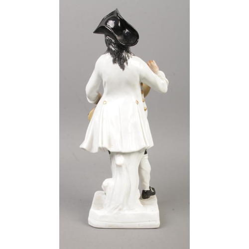19 - After Meissen, a continental Cries of Paris figure of a man with a hurdy gurdy. Height 21.5cm.