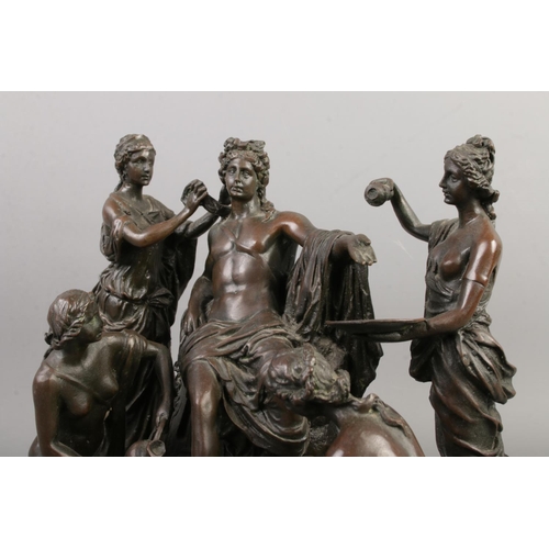 33 - A bronze figure group formed as a Roman being attended by four maidens raised on marble base. Inscri... 