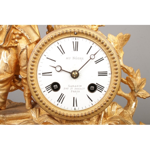 53 - A 19th century French gilt mantel clock under glass dome. The clock surmounted with a cavalier. The ... 
