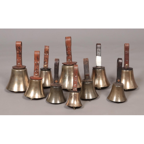55 - Ten early 20th century campanology hand bells with leather handles.