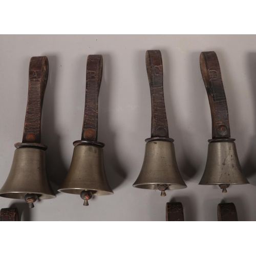 56 - Seventeen small early 20th century campanology hand bells with leather straps with maker's marks for... 