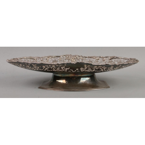 71 - A silver pedestal dish of oval form. Having scrollwork decoration with vine borders. Assayed Sheffie... 