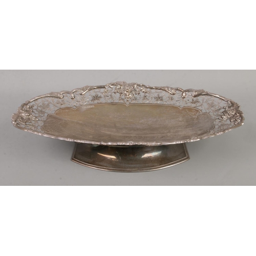 71 - A silver pedestal dish of oval form. Having scrollwork decoration with vine borders. Assayed Sheffie... 