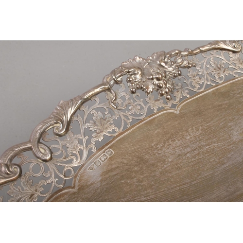 71 - A silver pedestal dish of oval form. Having scrollwork decoration with vine borders. Assayed Sheffie... 