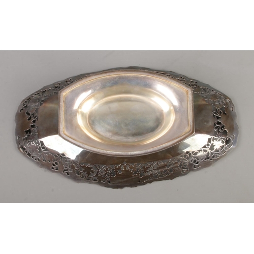 71 - A silver pedestal dish of oval form. Having scrollwork decoration with vine borders. Assayed Sheffie... 