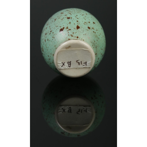 83 - A miniature porcelain pepper pot modelled as a blackbird egg. Having screw base. Height 3.5cm.