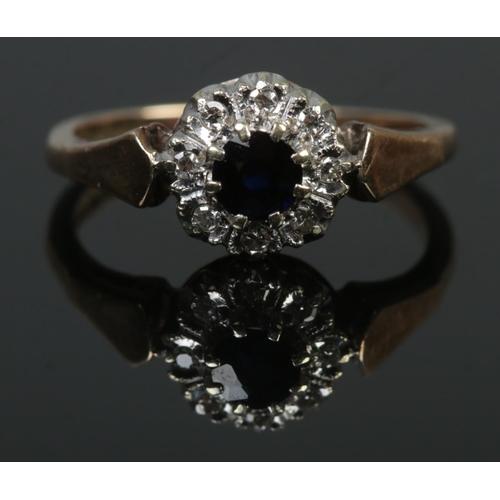 95 - A 9ct gold diamond and sapphire halo cluster ring. Hallmarks for 1981 by B&S. Size K 1/2. 2.39g.