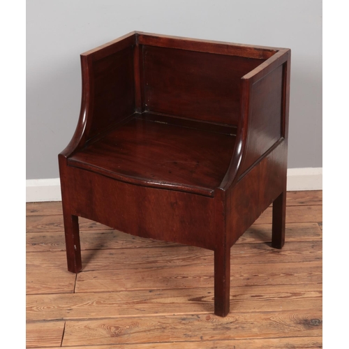 608 - A Georgian mahogany single settle/hall chair featuring storage compartment within seat.