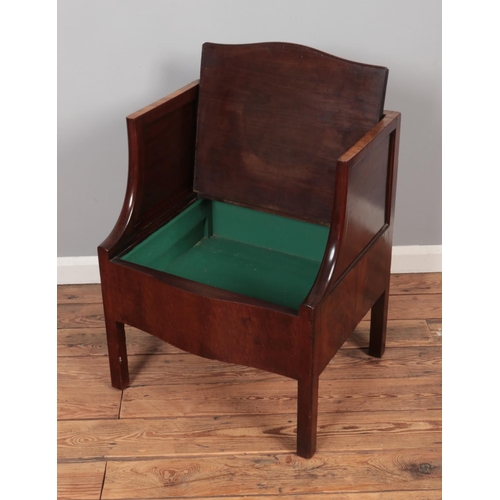 608 - A Georgian mahogany single settle/hall chair featuring storage compartment within seat.