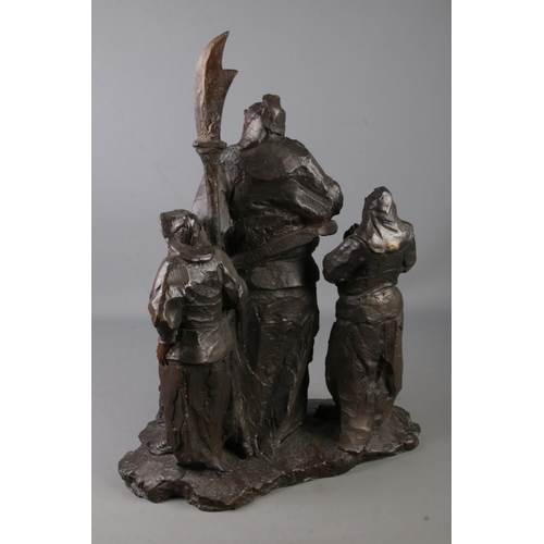 145 - A large bronze figure group depicting three oriental warriors. Indistinct signature to reverse of ce... 