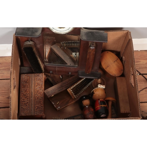 357 - A box of woodenware. Includes brushes, trays, boxes, barometer display/stand, etc.