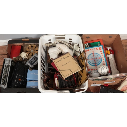 373 - Three boxes of miscellaneous. Includes radios, table top cricket game, knife handles, Black Label tr... 