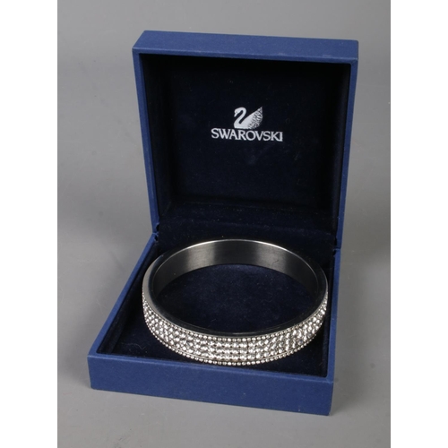 566 - A boxed Swarovski crystal white metal bangle.
6cm diameter internally.